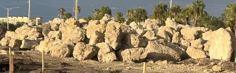 A massive pile of rocks along the shore.