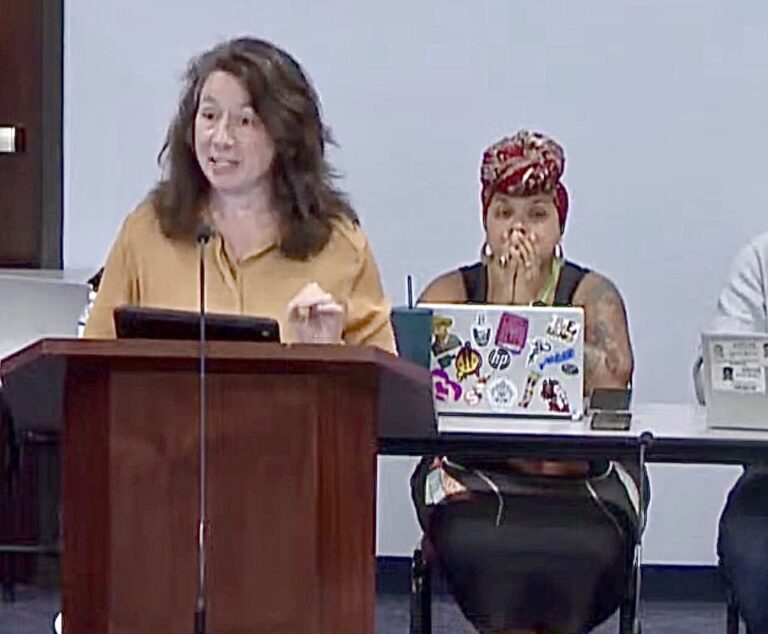 Elizabeth Ballard speaking at a podium.