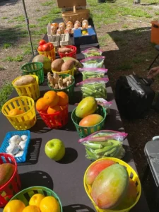 Baskets of produce arranged neatly on a table at an outdoor event.