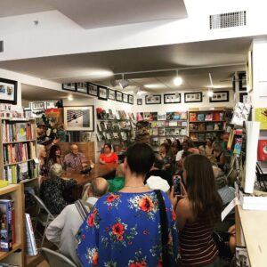A crowd gathered inside a small bookstore.
