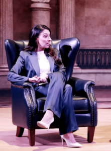 Erika Donalds speaking while sitting on stage.