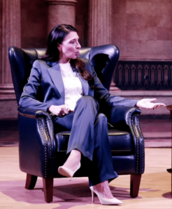 Erika Donalds speaking while sitting on stage.