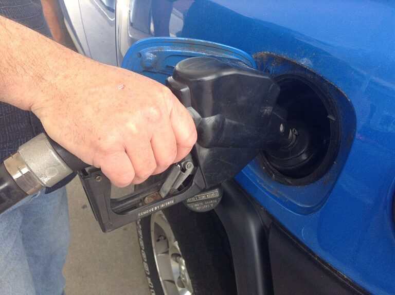 Close-up of a person filling their car's gas tank.