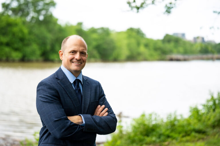 Jose Javier Rodriguez smiling in front of a body of water.