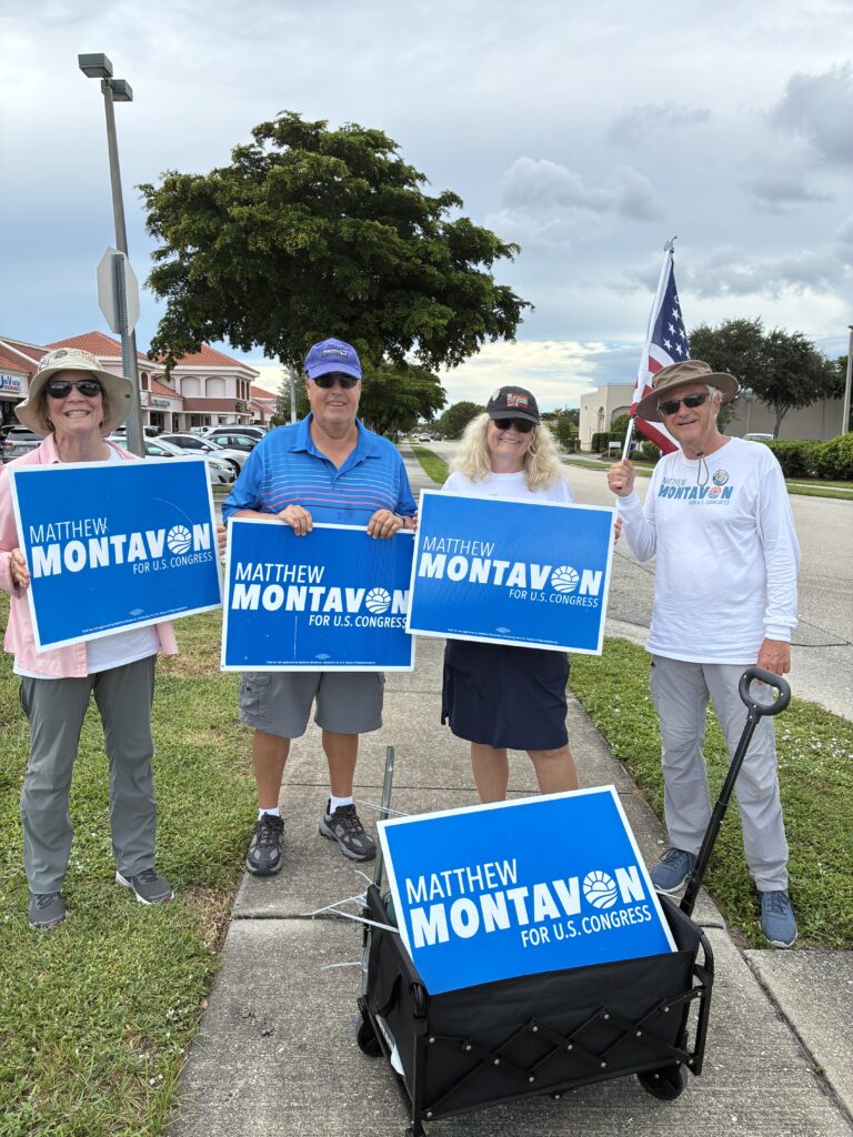 Matthew Montavon with supporters holding "Montavon for Congress" signs.