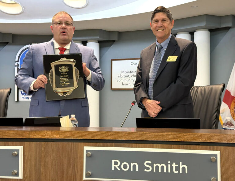 Nick Pachota presenting Ron Smith with an award.
