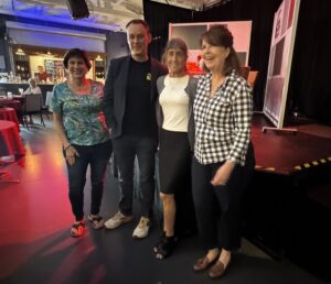Conni Brunni, Jason Garcia, Cathy Antunes and Carrie Seidman smiling arm in arm at Fogartyville.